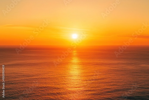 A serene sunset over the ocean with vibrant orange and red hues reflecting on the water at the beach, waves gently touching the shore under a sky filled with soft clouds