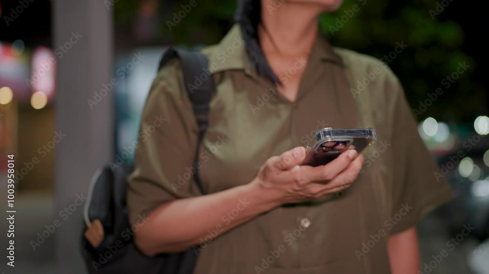Zoom in on a woman's phone as she waits for a ride in the stillness of night, capturing the quiet tension and hopefulness of the moment Zoom in on a woman's phone as she waits for a ride in the stillness of night, capturing the quiet tension and hopefulness of the moment