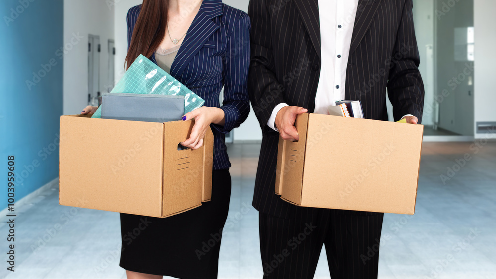 Fired people. Unemployed managers with boxes in hands. Mass layoff of office staff concept. Fired man and woman in empty room. Problem of unemployment in society. Reduction of white collar workers Fired people. Unemployed managers with boxes in hands. Mass layoff of office staff concept. Fired man and woman in empty room. Problem of unemployment in society. Reduction of white collar workers