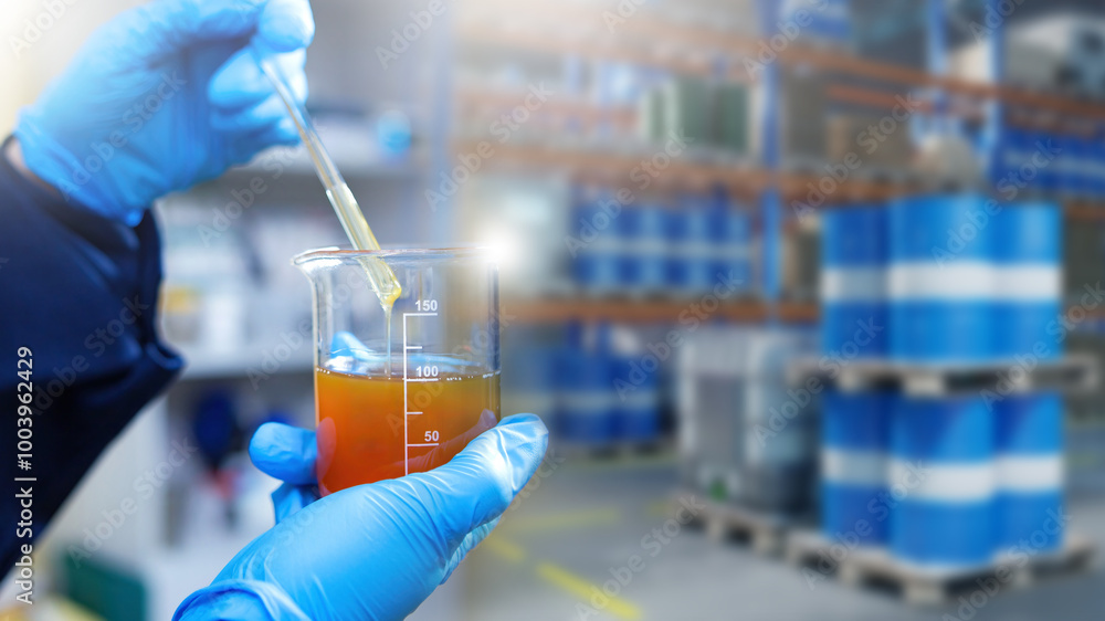 Analysis of oil in warehouse. Fuel quality control. Laboratory assistant with test tube in petroleum warehouse. Oil testing. Oil analysis to comply with environmental regulations. Selective focus Analysis of oil in warehouse. Fuel quality control. Laboratory assistant with test tube in petroleum warehouse. Oil testing. Oil analysis to comply with environmental regulations. Selective focus