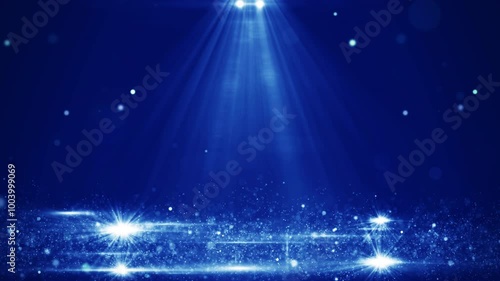 Blue stage scene illuminated with bright spotlights with shiny abstract particles floating in the air. Effect on dark blue background.