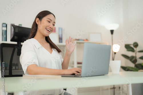 Confident businesswoman with laptop in modern office at home