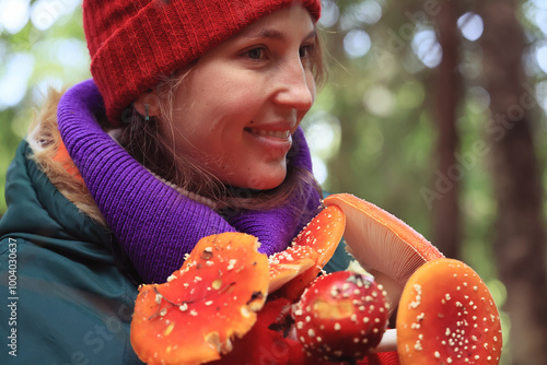 person fly agaric, woman holding fly agaric, dangerous poisonous mushroom, eating herbal medicine photo