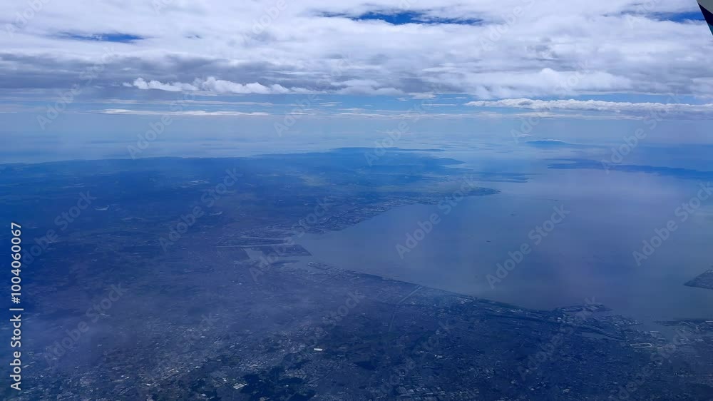 Coastline and expansive blue water under a cloudy sky , aerial view Coastline and expansive blue water under a cloudy sky , aerial view