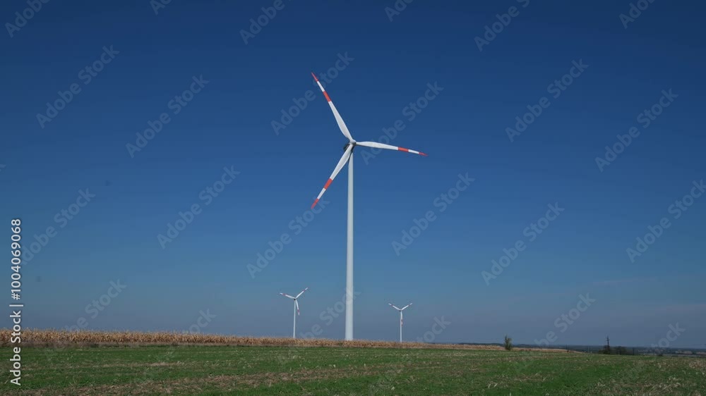 wind turbines on a green field under clear blue sky wind turbines on a green field under clear blue sky
