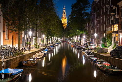 Photography Canal and the bell tower of Zuiderkerk in Amsterdam, Netherlands at night
