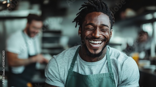 A joyful chef laughs heartily while engaging in a bustling kitchen environment, capturing the essence of camaraderie and culinary delight.