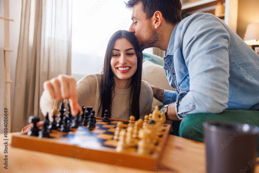 Couple relaxing at home playing chess Couple relaxing at home playing chess