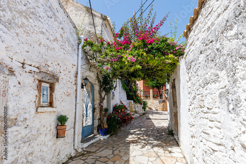 Alley decorated with flowers in the picturesque village of Afionas on the island of Corfu in Greece photo