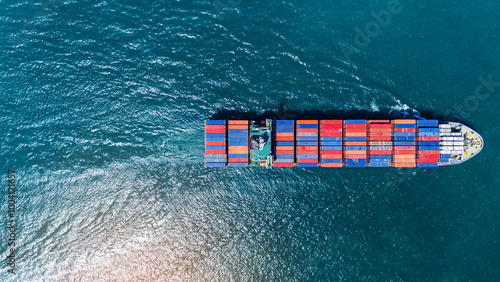 Photography Cargo container ship carrying container and running out international container port customs shipyard sea port concept smart logistic service