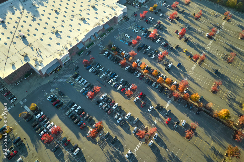 Aerial view of large parking lot in front of rgocery store with many parked colorful cars. Carpark at supercenter shopping mall with lines and markings for vehicle places and directions Aerial view of large parking lot in front of rgocery store with many parked colorful cars. Carpark at supercenter shopping mall with lines and markings for vehicle places and directions