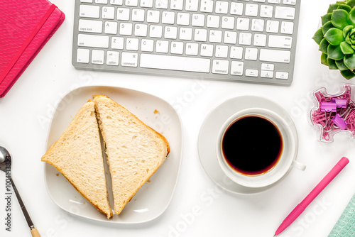 lunch in office with coffee and sandwich on white background flat lay photo