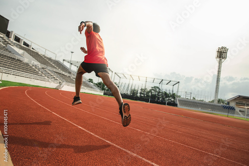 The runer runs on a red rubber running track, starting off using the starting block. Sports.Sprinter Leave the default block to track work. Young couple running on the road running for fitness.