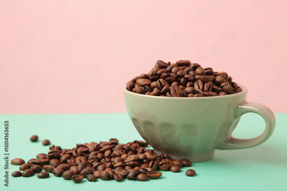 Fototapeta premium Coffee beans in coffee cup on colorful background.