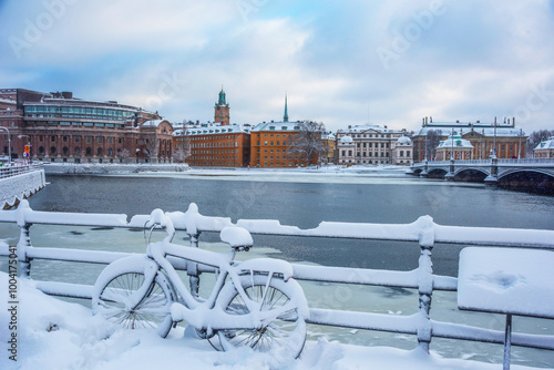 Snowy bike in front of government buildings a gray and snowy winter day in Stockholm