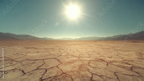 Wide-angle shot of a barren desert with cracked earth patterns stretching toward the horizon beneath a glaring sun.