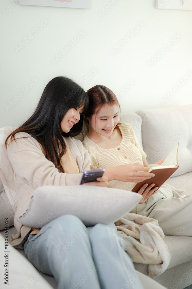 Asian female friends enjoying together on a sofa. Asian female friends enjoying together on a sofa.