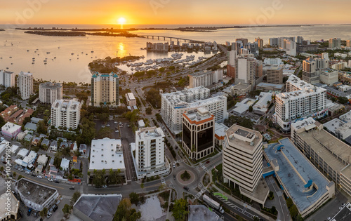 Sarasota, Florida at sunset. Luxury yachts docked in Sarasota Bay marina. American city downtown architecture with high-rise office buildings. USA travel destination photo