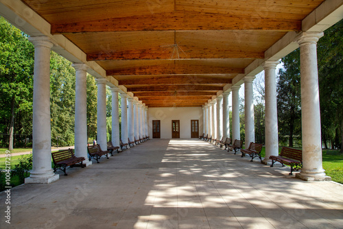 Canvas Print The gallery is old with round columns and wooden beams on a clear sunny day