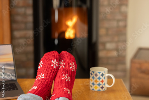 Woman warming herself in front of a pellet stove