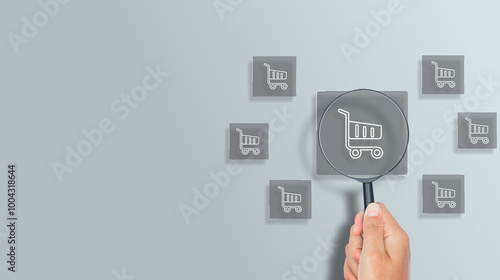 Business ecommerce concept, magnifying glass focus on online shopping cart icon on virtual screen. online purchase, ecommerce store, online business, shopping on the internet.