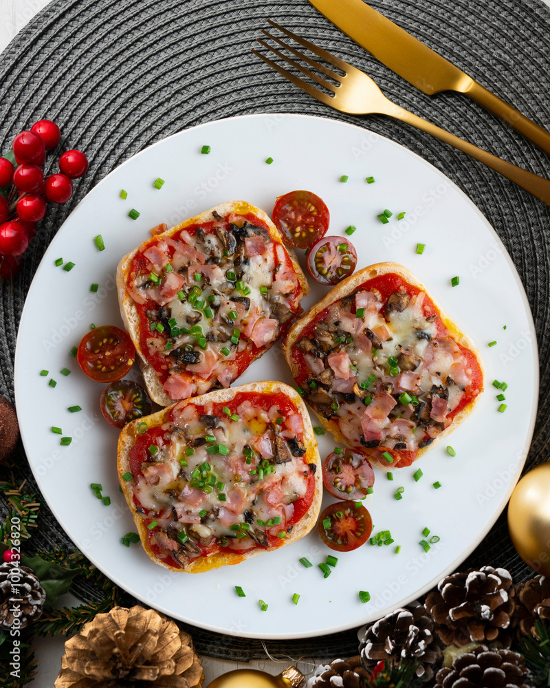 Ham and mini pizzas with mushrooms. Top view table with Christmas decoration. Ham and mini pizzas with mushrooms. Top view table with Christmas decoration.