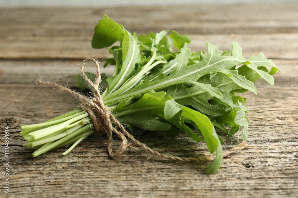 Bunch of fresh green arugula leaves on wooden table, closeup Bunch of fresh green arugula leaves on wooden table, closeup