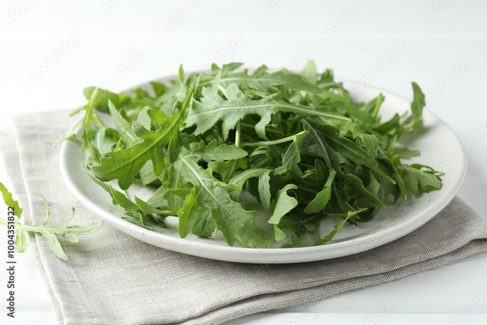 Fresh green arugula leaves on white table, closeup Fresh green arugula leaves on white table, closeup