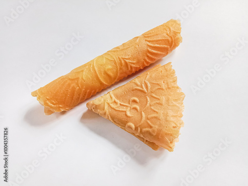 Kue semprong, Asian egg roll, sapit, sepit or kapit. Indonesian traditional wafer snack made by clasping egg batter using an iron mold. photo