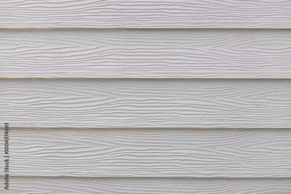 Close-up of white horizontal plastic planks with wooden texture, highlighting the detailed imitation of natural wood. The subtle, intricate design perfect for various decor and artistic applications. Close-up of white horizontal plastic planks with wooden texture, highlighting the detailed imitation of natural wood. The subtle, intricate design perfect for various decor and artistic applications.