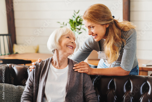 Photos Middle aged nurse taking care of old woman indoors