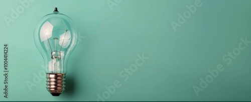 Vintage Lightbulb Illuminating a Mint Green Wall in a Contemporary Setting
