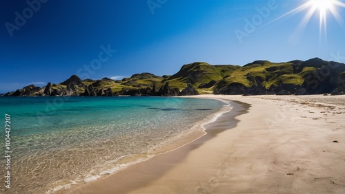 Tranquil beach with clear water and rugged green hills