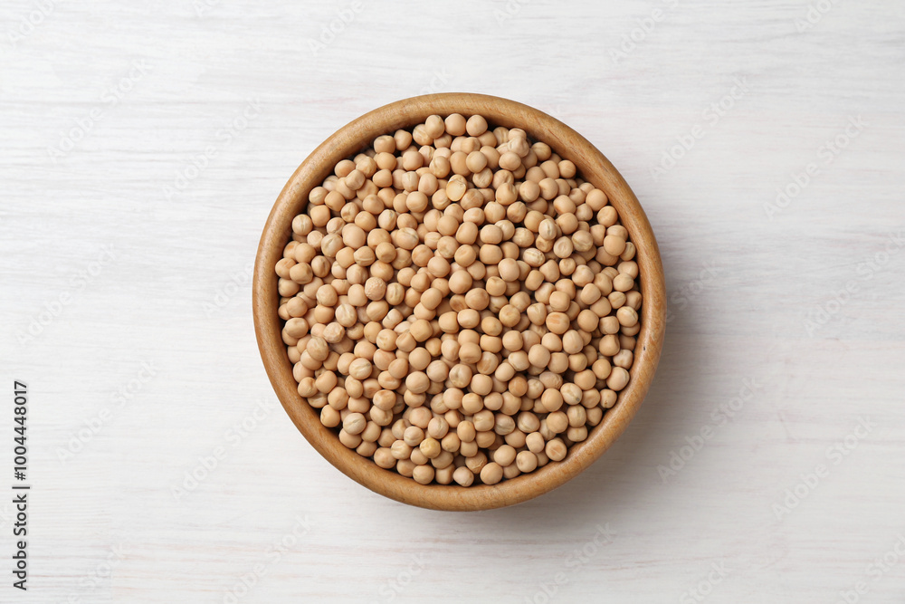 Dried peas in bowl on light wooden table, top view Dried peas in bowl on light wooden table, top view
