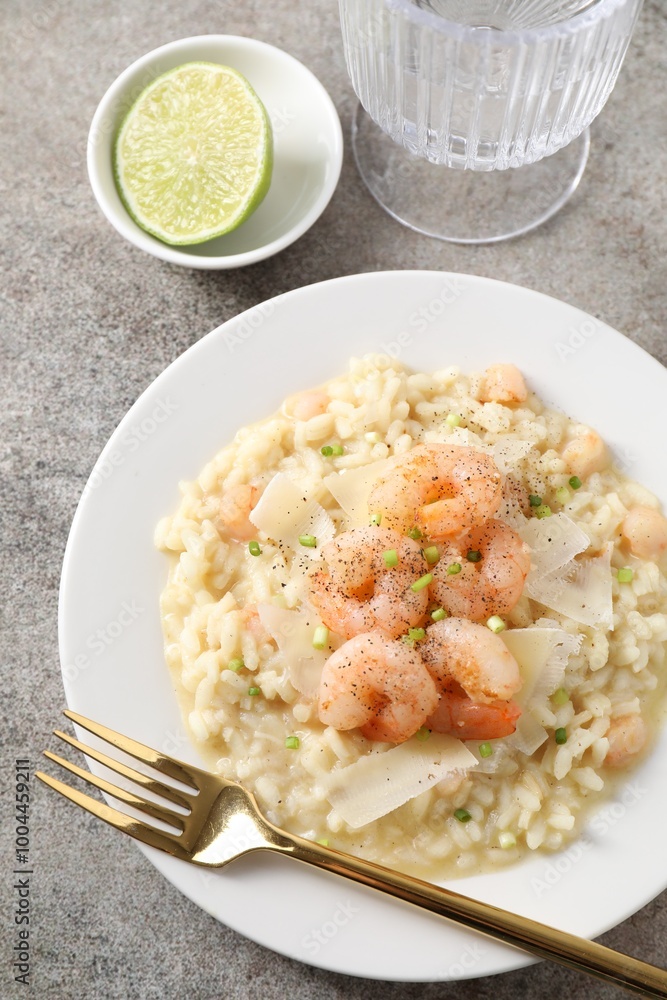 Delicious risotto with shrimps and cheese on grey table, top view Delicious risotto with shrimps and cheese on grey table, top view