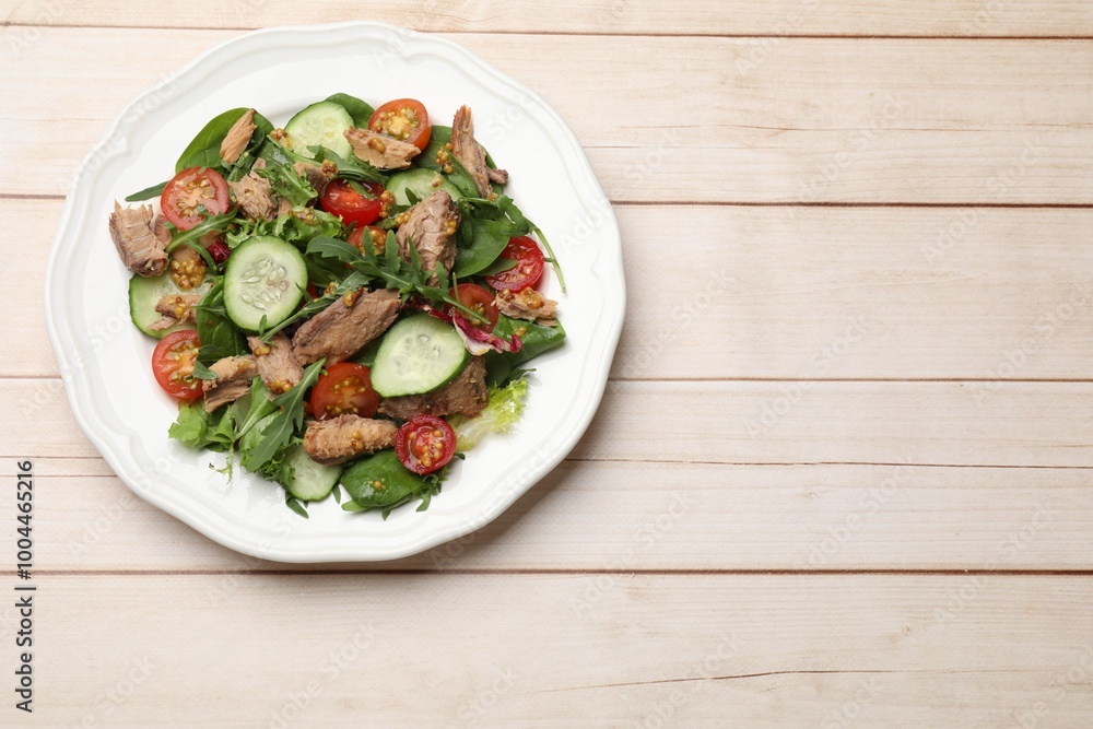 Delicious fresh tuna salad on white wooden table, top view. Space for text Delicious fresh tuna salad on white wooden table, top view. Space for text