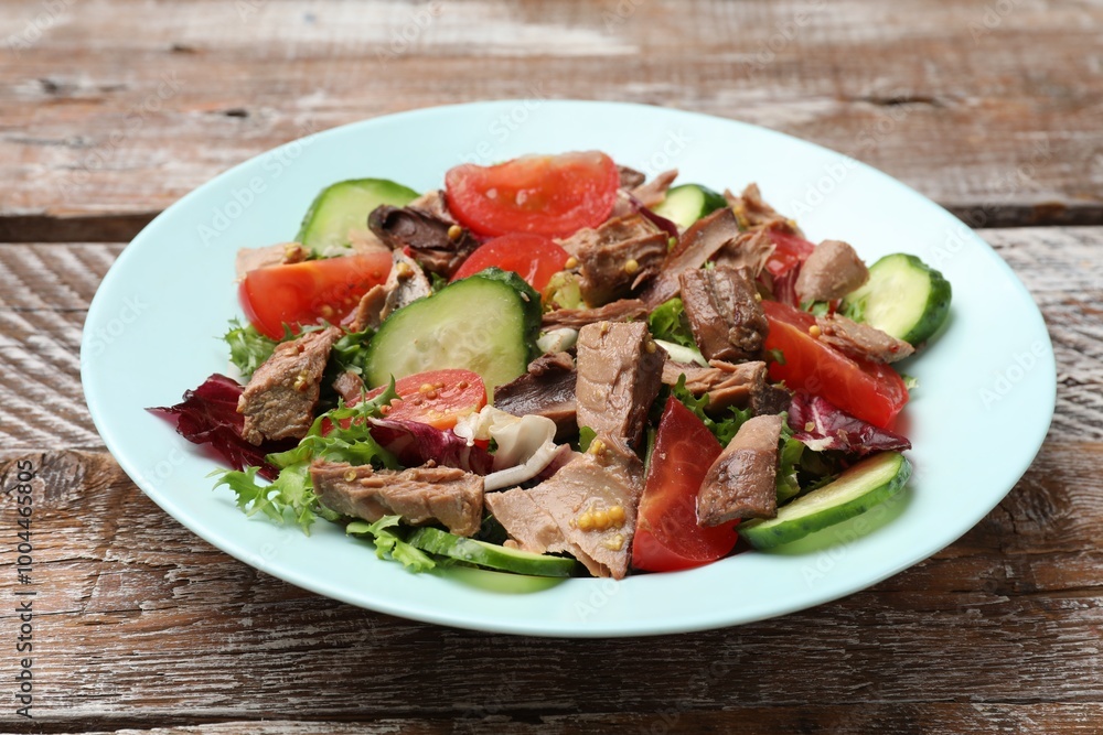 Delicious fresh tuna salad on wooden table, closeup Delicious fresh tuna salad on wooden table, closeup