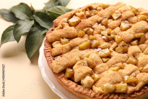 Tasty homemade apple pie on beige background, closeup