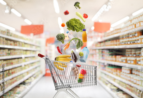 Groceries falling inside a shopping cart photo