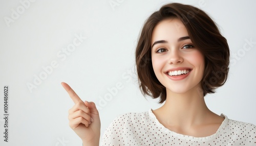 Beautiful Female Customer Representative Smiling With Headset, Pointing At Copy Space On White Background. Positive Emotions And Facial Expressions Captured.