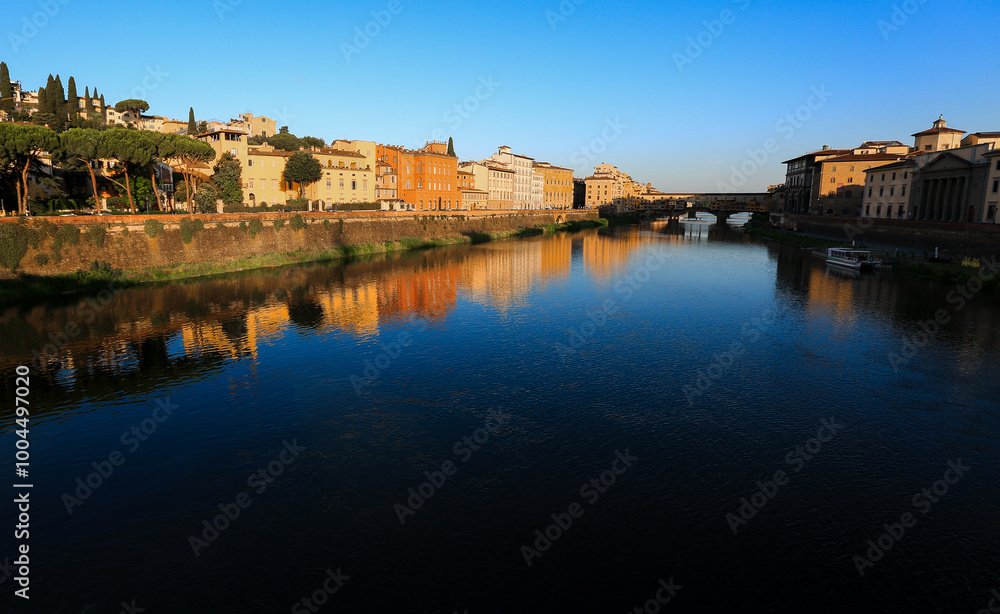 Golden Reflections on the Arno River, Florence
The warm glow of the setting sun reflects on the Arno River and the historic buildings along its banks, with the Ponte Vecchio visible in the distance. Golden Reflections on the Arno River, Florence
The warm glow of the setting sun reflects on the Arno River and the historic buildings along its banks, with the Ponte Vecchio visible in the distance.