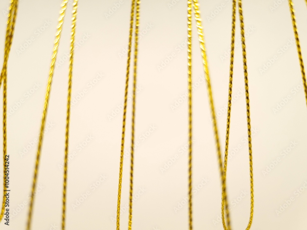 Festive background. Gold glittering threads on white background. Defocused Festive background. Gold glittering threads on white background. Defocused