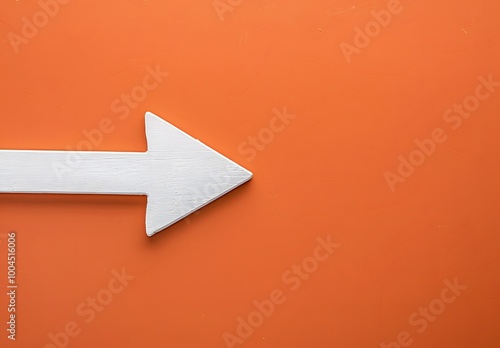White Arrow Sign on Orange Background with Copy Space