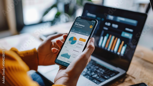 A person using a mobile banking app to check balances, transfer money, and receive real-time updates on financial activities.