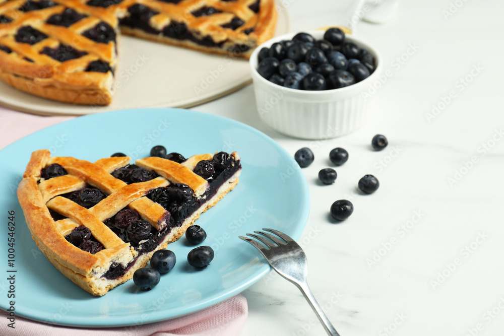 Piece of tasty homemade pie with blueberries served on white marble table Piece of tasty homemade pie with blueberries served on white marble table