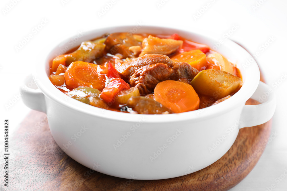 Delicious stew with vegetables in bowl on white table, closeup Delicious stew with vegetables in bowl on white table, closeup