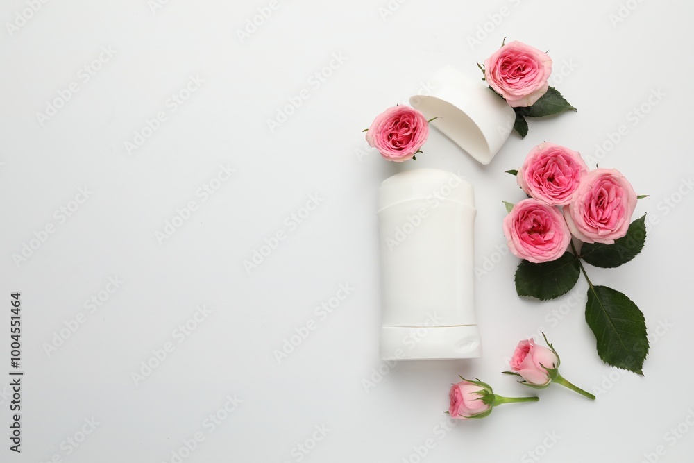 Solid deodorant and beautiful rose flowers on white background, flat lay. Space for text Solid deodorant and beautiful rose flowers on white background, flat lay. Space for text