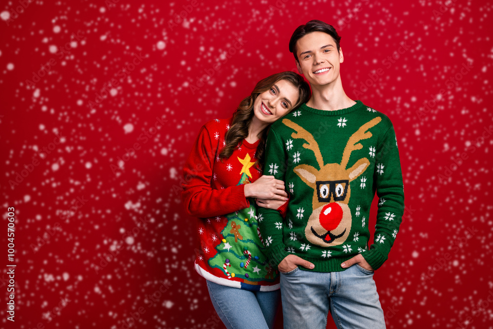 Photo of cute tender couple husband wife holds hand enjoy comfort clothes cozy time empty space isolated on red color background Photo of cute tender couple husband wife holds hand enjoy comfort clothes cozy time empty space isolated on red color background