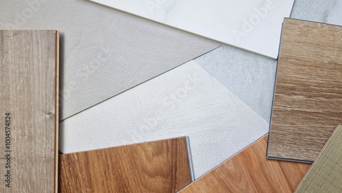 top view of interior material mood and tone board contains wooden vinyl tiles, laminated flooring tile, concrete laminated, ceramic marble tile in close up view. stylish decoration materials.