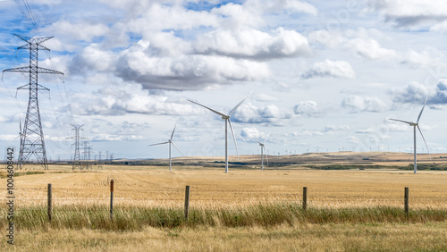 Wind power towers and power line on  agricultural field  at fall season
